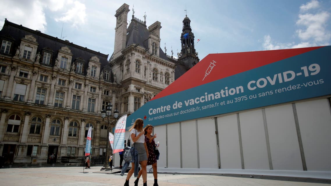 Women walk past a coronavirus disease (COVID-19) vaccination center installated in front of Paris town hall, France, July 7, 2021. (Reuters)