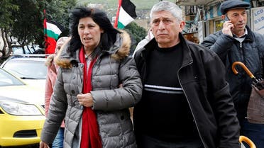 File photo of Khalida Jarrar, a senior Popular Front for the Liberation of Palestine's (PFLP) political figure, walks with people after she was released from an Israeli jail, in Nablus, in the Israeli-occupied West Bank, on February 28, 2019. (Reuters)