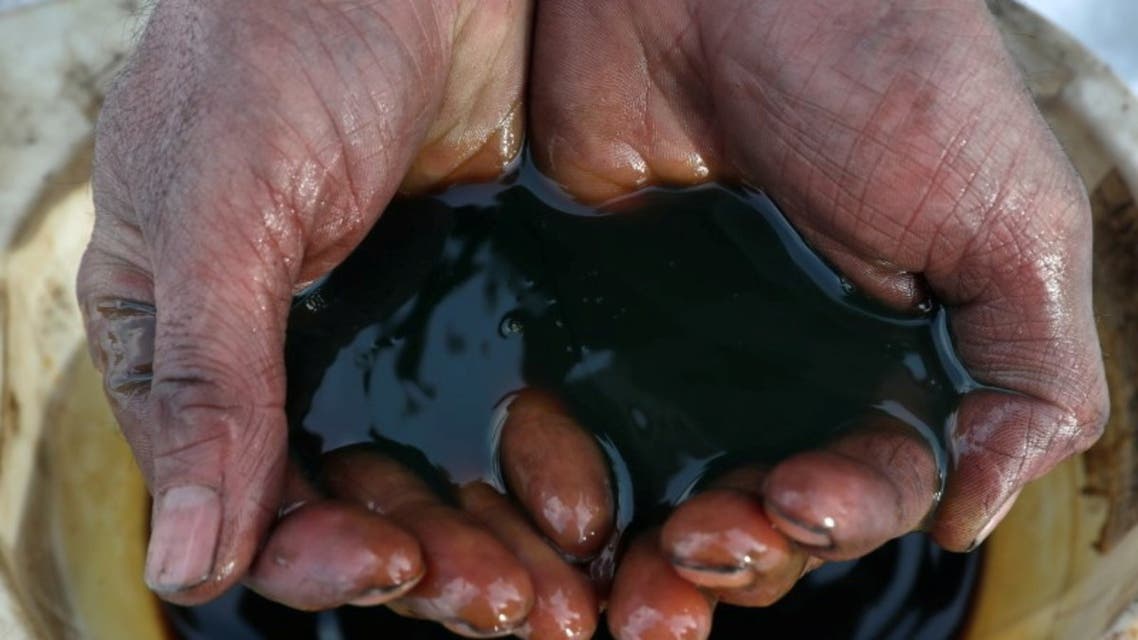 An employee demonstrates a sample of crude oil in the Yarakta Oil Field, owned by Irkutsk Oil Company (INK), in Irkutsk Region, Russia in this picture illustration taken March 11, 2019.  (Reuters)