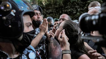 A protester argues with security forces as demonstrators and families of the Beirut blast victims gather outside the residence of Lebanon's Interior Minister, July 13, 2021. (AFP)