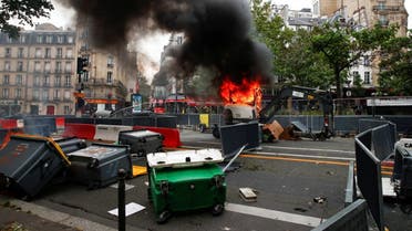 A view shows a burning backhoe loader during a demonstration against the new measures announced by French President Emmanuel Macron to fight the coronavirus outbreak, in Paris, France, on July 14, 2021. (Reuters)