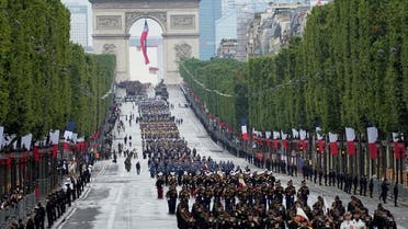 Troops walk down the Champs-Elysees avenue during the Bastille Day parade in Paris, France, July 14, 2021. (Michel Euler/Pool via Reuters)