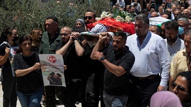 Palestinian mourners carry the body of Suha Jarrar, 30-year-old daughter of Khalida Jarrar, who is a prisoner in an Israeli jail, during her funeral, in the West Bank city of Ramallah, Tuesday, July 13, 2021. (AP/Majdi Mohammed)