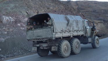 Ethnic Armenian soldiers drive a truck while leaving Karvatchar town in the region of Nagorno-Karabakh, November 24, 2020. The recent signing of a ceasefire deal ended a military conflict between Azerbaijan's troops and ethnic Armenian forces in the breakaway region. Picture taken November 24, 2020. (Reuters)