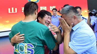 Guo Gangtang, 51, and his wife reunite with their son Guo Xinzhen, who was abducted 24 years ago at the age of 2, at a family reunion arranged by the police, in Liaocheng, Shandong province, China July 11, 2021. Picture taken July 11, 2021. China Daily via REUTERS ATTENTION EDITORS - THIS IMAGE WAS PROVIDED BY A THIRD PARTY. CHINA OUT.