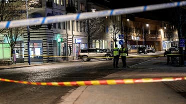 Police officers work behind barricade tape at a knife attack site in Vetlanda, Sweden March 3, 2021. (Reuters)