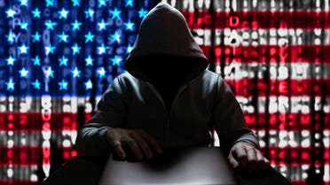 Cyberattack from the USA. An American hacker turns on a laptop, sitting at a table, on a background of binary code, the colors of the USA flag. DDoS attack stock photo