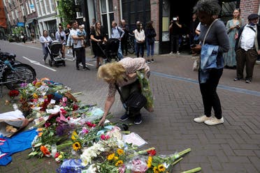 A woman leaves flowers where Dutch celebrity crime reporter Peter R. de Vries has been shot and reported seriously injured in Amsterdam, Netherlands, on July 7, 2021. (Reuters)