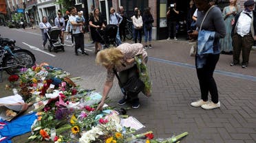 A woman leaves flowers where Dutch celebrity crime reporter Peter R. de Vries has been shot and reported seriously injured in Amsterdam, Netherlands, on July 7, 2021. (Reuters)