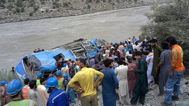 Rescue workers and onlookers gather around a wreck after a bus plunged into a ravine following a bomb explosion, which killed 12 people including 9 Chinese workers, in Kohistan district of Khyber Pakhtunkhwa province on July 14, 2021. (File photo: AFP)