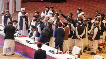 Members of the Taliban delegation leave their seats at the end of the session during the peace talks between the Afghan government and the Taliban in the Qatari capital Doha on September 12, 2020.
