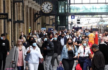People wearing protective face masks walk along a platform at King's Cross Station, amid the coronavirus disease (COVID-19) outbreak in London, Britain, July 12, 2021. (Reuters)