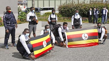 Members of Uganda's Olympic team pose for a photograph upon their arrival at their pre-Olympics camp host town, after a member of their team has tested positive for the coronavirus disease (COVID-19) and was barred entry into Japan, in Izumisano, Osaka . (Reuters)