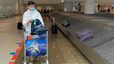 A Saudi pilgrim waits for his luggage at King Abdulaziz airport in Jeddah, on July 15, 2021. (AFP)