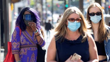 People wearing face protective masks walk on Hollywood Blvd during the outbreak of the coronavirus disease (COVID-19), in Los Angeles. (File Photo: Reuters)