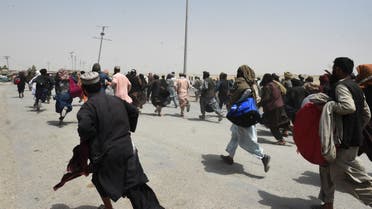 People rush towards a border crossing point in Pakistan's border town of Chaman on July 17, 2021, after Pakistan partially reopened its southern crossing with Afghanistan, shut off since the Taliban seized control of the strategic border town on the other side. (AFP)