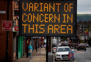  A woman walks past an information sign amid the outbreak of the coronavirus disease (COVID-19) in Bolton, Britain, May 17, 2021. (File Photo: Reuters)