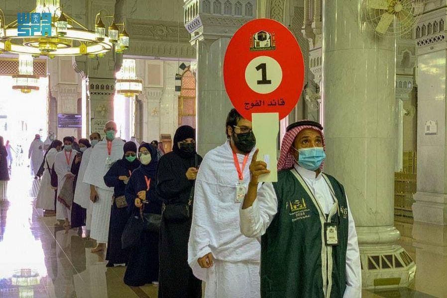 A guide leads Muslims as they begin the Hajj ritual on July 17, 2021 amid the coronavirus pandemic in Mecca, Saudi Arabia. (SPA)