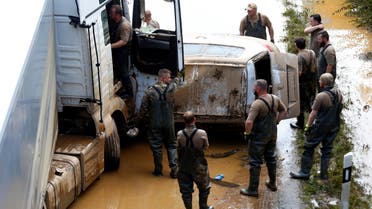 Members of the Bundeswehr forces recover cars on a flooded road following heavy rainfalls in Erftstadt-Blessem, Germany, July 17, 2021. (Reuters)