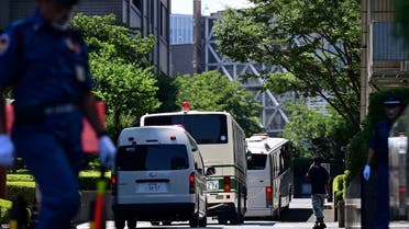 A bus believed to be carrying former US special forces member Michael Taylor and his son Peter arrives at the Tokyo district court ahead of their verdict in Tokyo on July 19, 2021. (Philip Fong/AFP)