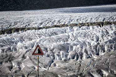This picture taken on October 01, 2019 shows a warning sign for rockslide next to the Aletsch glacier above Bettmeralp, Swiss Alps.The mighty Aletsch – the largest glacier in the Alps – could completely disappear by the end of this century if nothing is done to rein in climate change, a study showed on September 12, 2019 by ETH technical university in Zurich. (Fabrice Coffrini/AFP)