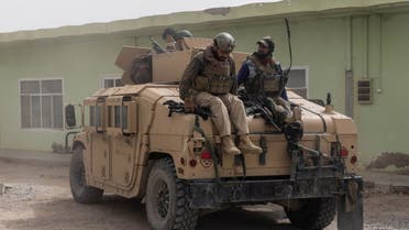 Members of Afghan Special Forces climb down from a humvee as they arrive at their base after heavy clashes with Taliban during the rescue mission of a police officer besieged at a check post, in Kandahar province, Afghanistan, July 13, 2021. (Reuters)