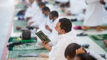 A pilgrim reads the Quran in the Al Namirah Mosque in Arafat during Hajj, in Mecca. (Photo Courtesy: The Two Holy Mosques Twitter)