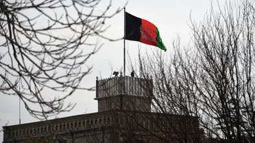 An Afghan security personnel keeps watch on a tower as the Afghan national flag flutters ahead of the start of Afghanistan President Ashraf Ghani's swearing-in inauguration ceremony, at the Presidential Palace in Kabul on March 9, 2020. (AFP)