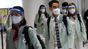 South Korea team members wearing protective face masks and face shields arrive at Narita International Airport ahead of the Tokyo 2020 Olympic Games on July 19, 2021. (Reuters)