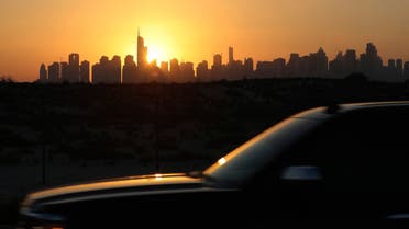  The sunlight reflects on a car glass as it sets behind the city skyline at the Marina and Jumeirah Lake Towers districts in Dubai, United Arab Emirates, Friday, Feb. 26, 2021. (AP Photo/Kamran Jebreili)