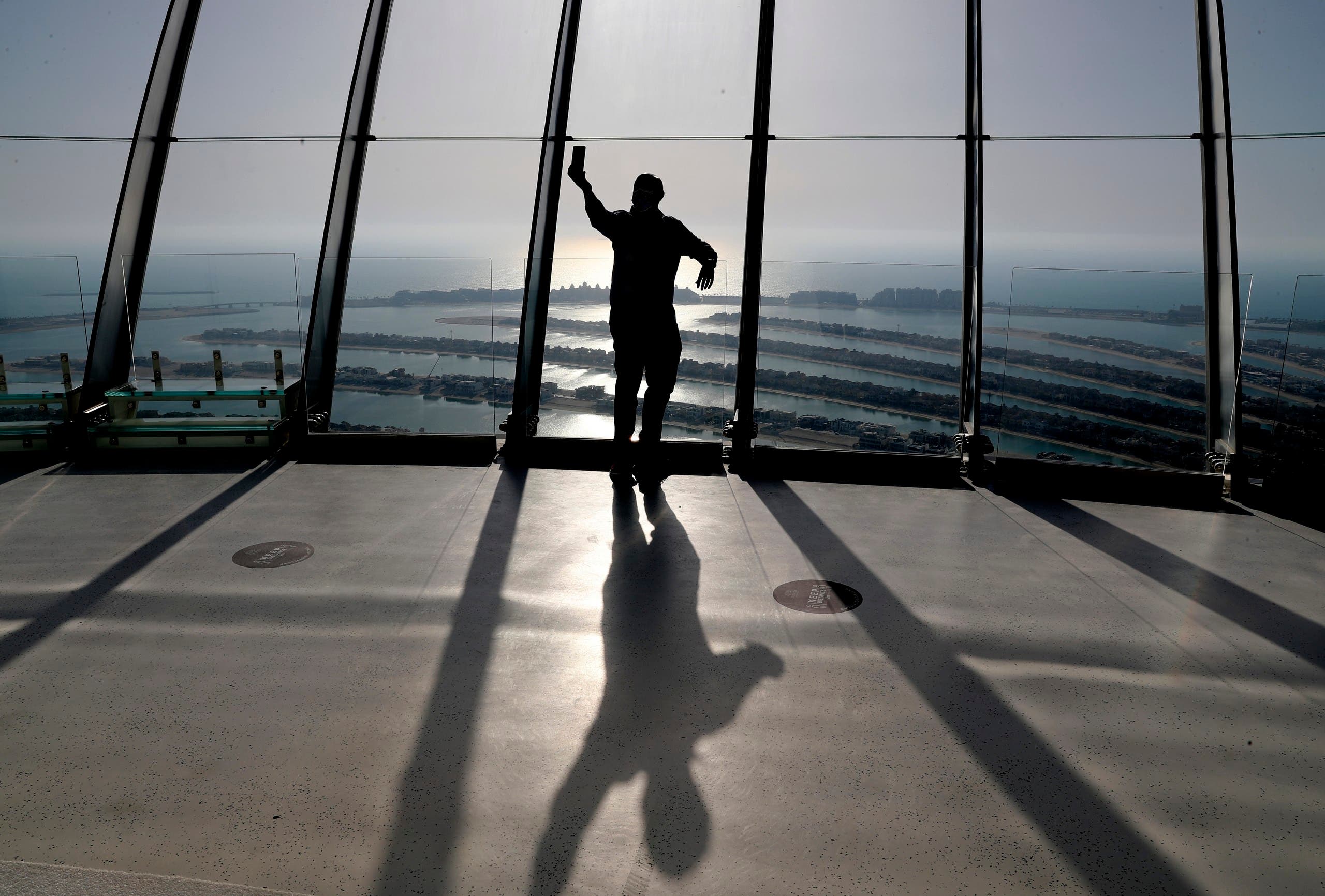 A man takes selfie on the observation deck of The View at The Palm Jumeirah in Dubai, United Arab Emirates, Tuesday, April 6, 2021. (AP)