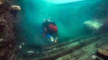 A handout picture released on July 19, 2021 shows a diver exploring the hull of a military vessel discovered in the sunken city of Thonis-Heracleion in Abu Qir bay, on Egypt’s northern Mediterranean coast. (Egyptian Ministry of Antiquities/AFP)