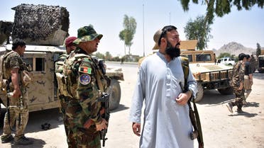 Afghan security personnel stand guard along the road amid ongoing fight between Afghan security forces and Taliban fighters in Kandahar on July 9, 2021.