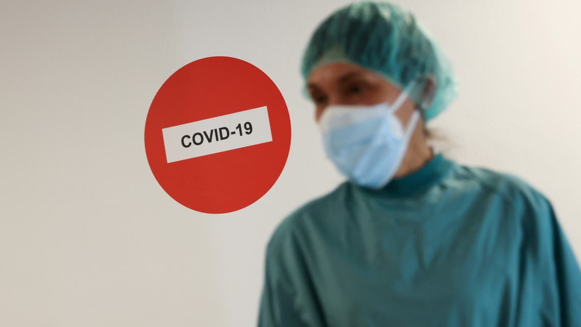 FILE PHOTO: A hospital staff member is pictured before treating a patient suffering from the coronavirus disease (COVID-19) at Hospital del Mar, where an additional ward has been opened to deal with an increase in coronavirus patients in Barcelona, Spain July 15, 2021. REUTERS/Nacho Doce/File Photo