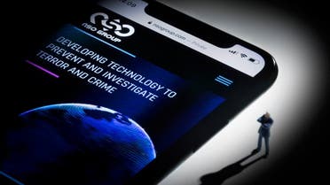 This studio photographic illustration shows a smartphone with the website of Israel's NSO Group which features 'Pegasus' spyware, on display in Paris on July 21, 2021. (AFP)