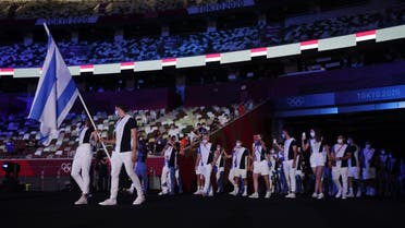Flag bearers Yakov Toumarkin of Israel and Hanna Knyazyeva-Minenko of Israel lead their contingent during the athletes’ parade at the opening ceremony  at the Olympic Stadium, Tokyo, Japan, on July 23, 2021. (Reuters)