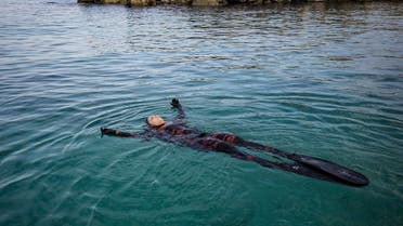 Ghadir Jamal, 31, one of the few Lebanese women who practice spearfishing, floats atop the water off the coast of the coastal town of Qalamun near the port city of Tripoli, Lebanon on Nov. 8, 2020. (AFP)