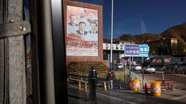 A bus carrying foreign journalists on a government tour passes by portraits of Chinese President Xi Jinping and former leaders Jiang Zemin, Mao Zedong, Deng Xiaoping and Hu Jintao at a checkpoint in Lhasa, Tibet Autonomous Region, China, on October 14, 2020. (Reuters)