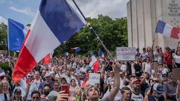  Thousands of protesters gather at Place Trocadero near the Eiffel Tower attend a demonstration in Paris, France, Saturday July 24, 2021, against the COVID-19 pass which grants vaccinated individuals greater ease of access to venues. (AP)