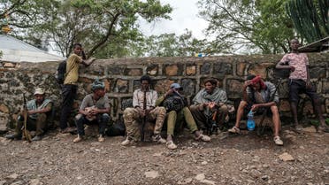 Members of the Amhara militia rest next to a wall in the village of Adi Arkay, 180 kilometers northeast from the city of Gondar, Ethiopia, on July 14, 2021. On Wednesday the Amhara government spokesman Gizachew Muluneh announced that regional special forces and militias would shift to attack mode to reverse the recent battlefield gains by the Tigrayan rebels.