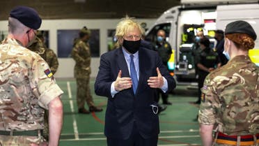 British PM Boris Johnson meets with military medics during a visit to Joint Helicopter Command Flying Station Aldergrove, Northern Ireland, March, 12, 2021. (Peter Morrison/Pool via Reuters)