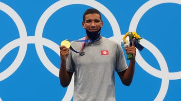 Gold medalist Ahmed Hafnaoui of Tunisia poses on the podium. (Reuters)