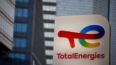 The logo of French oil and gas company TotalEnergies is pictured at an electric car charging station and petrol station at the financial and business district of La Defense in Courbevoie near Paris, France, June 22, 2021. (Reuters)