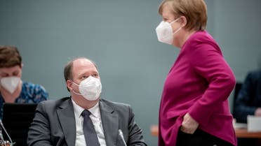 German Chancellor Angela Merkel wears a protective face mask as she talks to Chancellery's Chief of Staff Helge Braun before the weekly cabinet meeting of the German government at the chancellery in Berlin, Germany, March 3, 2021. (Reuters)