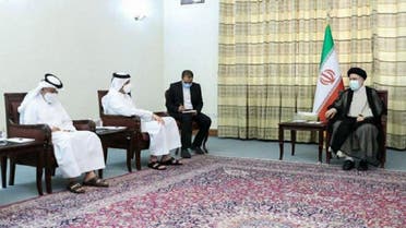A handout picture provided by the office of Iran’s President-elect Ebrahim Raisi shows him (R) meeting with Qatari FM Sheikh Mohammed Bin Abdulrahman Al-Thani (2nd-L) at his office in Tehran, July 25, 2021. (AFP)