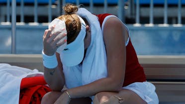Anastasia Pavlyuchenkova of the Russian Olympic Committee holds an ice pack to her head during a changeover against Sara Errani of Italy (not pictured) in a women's singles first round match during the Tokyo 2020 Olympic Summer Games at Ariake Tennis Park. (Reuters)
