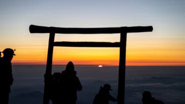 This photo taken on July 19, 2021 shows people watching the sunrise from the summit of Mount Fuji, some 70 kilometres (43 miles) west of the capital Tokyo. (AFP)
