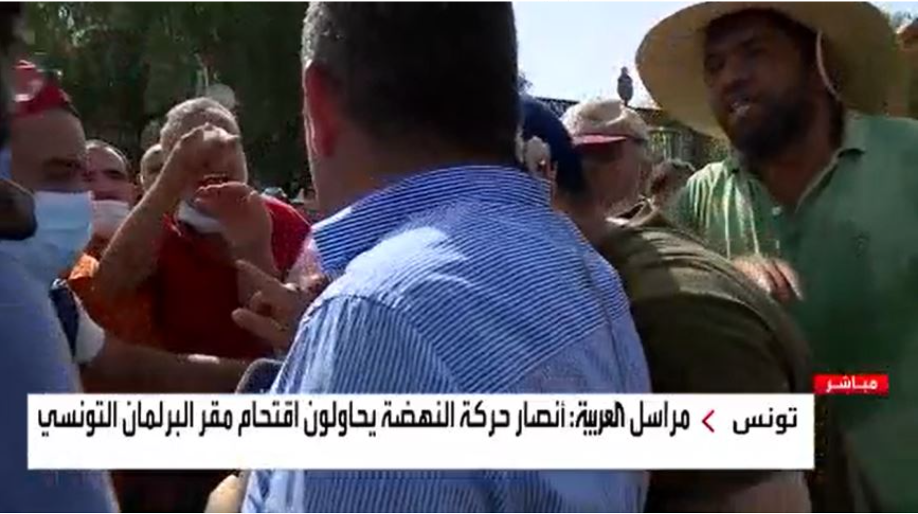 An attempt by Ennahda supporters to attack a reporter "Arabic" Before Parliament