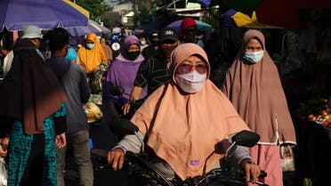 People wearing protective masks are pictured as they shop at a traditional market as government eases the emergency restrictions amid the coronavirus disease (COVID-19) pandemic in the capital of Jakarta, Indonesia, July 26, 2021. (Reuters)