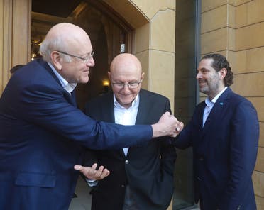 Former Lebanese PM Saad Hariri and PM-designate Najib Mikati greet each other in Beirut, July 25, 2021. (Reuters)